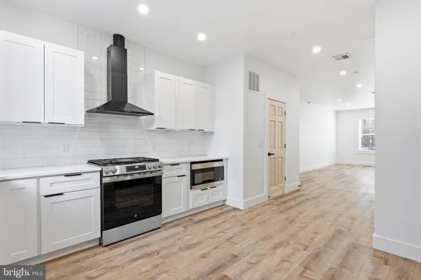 a kitchen with stainless steel appliances granite countertop a stove and a sink
