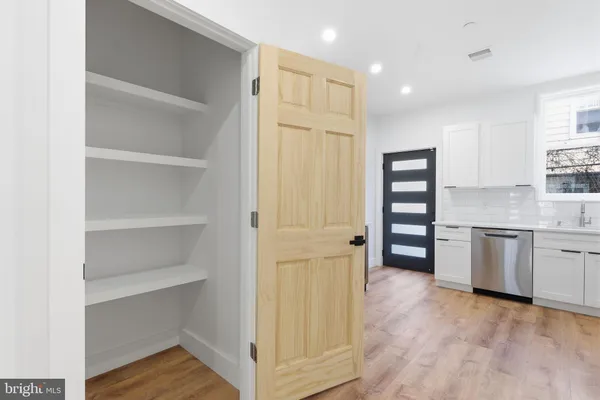 a view of cabinets with wooden floor and electronic appliances