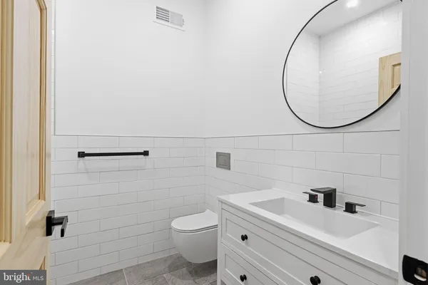 a bathroom with a sink a toilet and a mirror