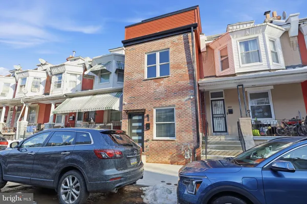 a front view of a house with parking space