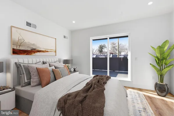 a bed room with a bed and a painting on the wall