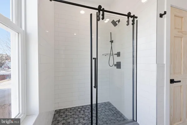 a bathroom with a toilet and a shower