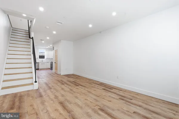 a view of a hallway with stairs and a window