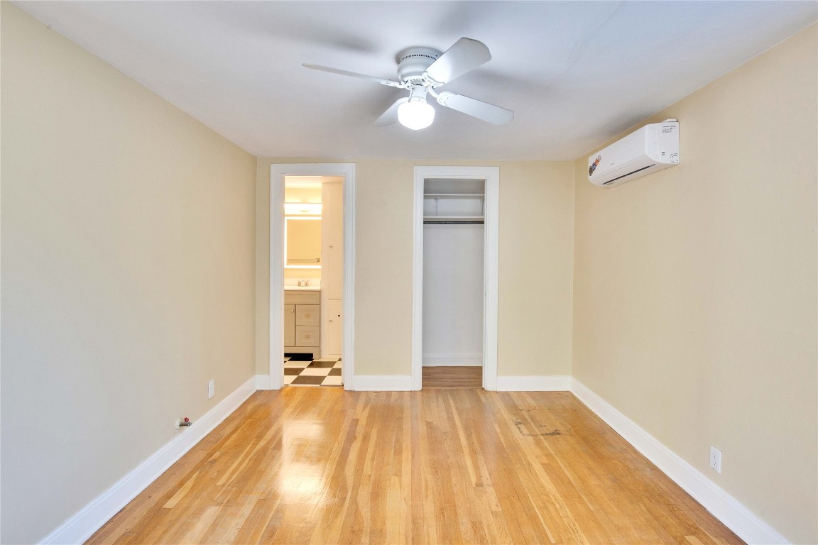 1115 Enfield Road, Unit C Austin, TX 78703 - Photo 11 of 26 a view of a room with wooden floor and a ceiling fan