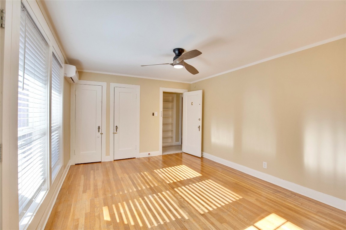 1115 Enfield Road, Unit C Austin, TX 78703 - Photo 12 of 26 a view of a room with wooden floor and a ceiling fan