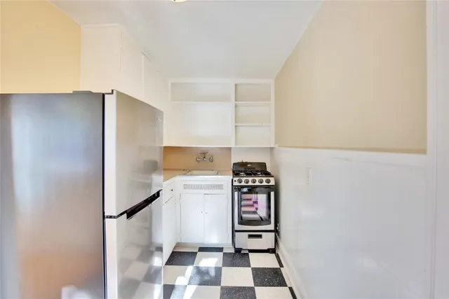 a kitchen with a refrigerator and a sink