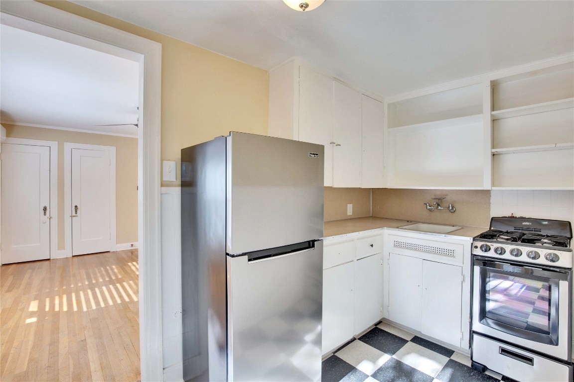 1115 Enfield Road, Unit C Austin, TX 78703 - Photo 17 of 26 a kitchen with a refrigerator and a stove top oven
