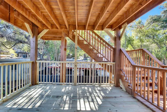 a view of balcony with wooden floor and fence