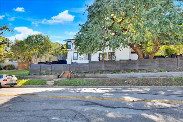 a view of a yard with plants and trees