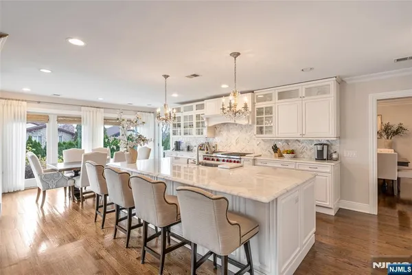 a kitchen with appliances cabinets and wooden floor