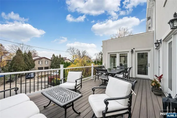 a view of a chairs and table in the roof deck
