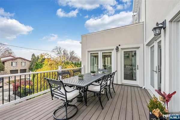 a view of a patio with table and chairs and wooden floor