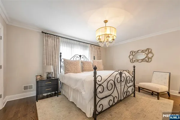 a bedroom with a bed and a chandelier