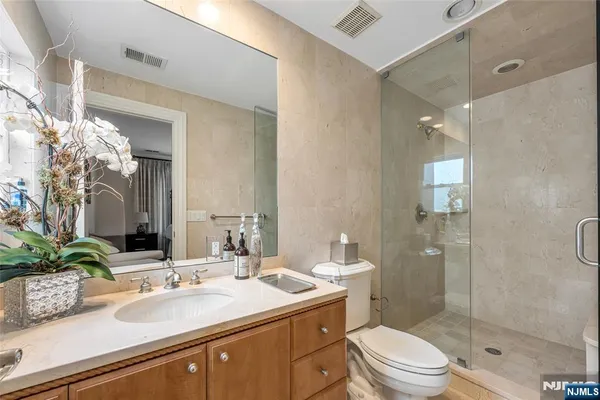a bathroom with a sink a toilet and shower