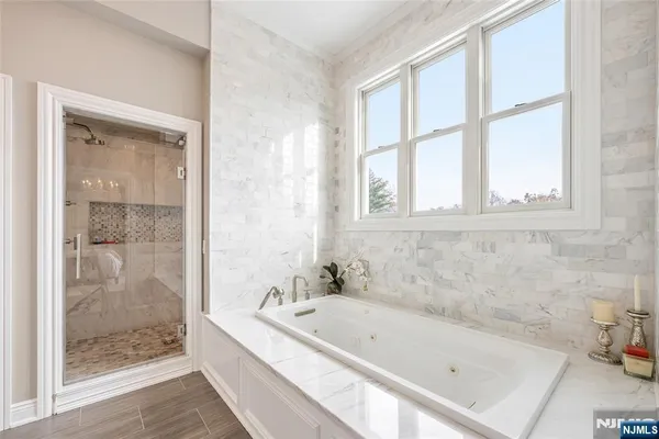 a bathroom with a bathtub and a shower