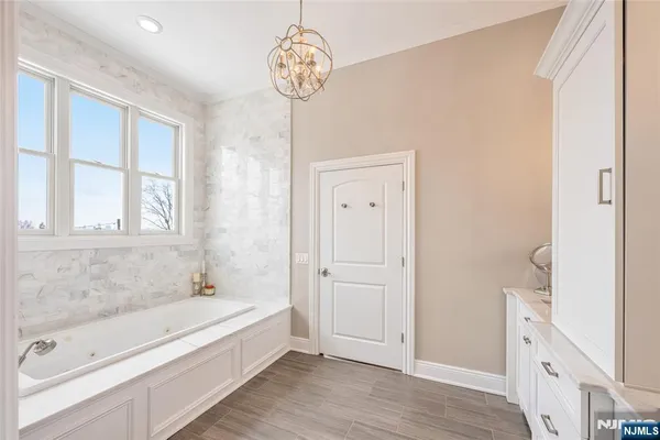 a bathroom with a bathtub and a shower