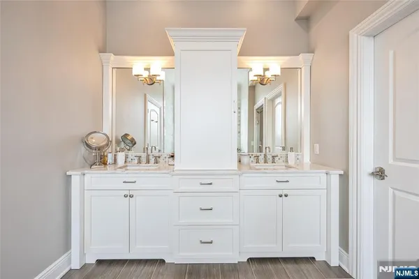 a bathroom with a sink vanity and a mirror