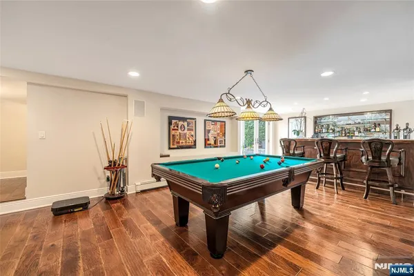 a room with furniture pool table gym equipment and windows