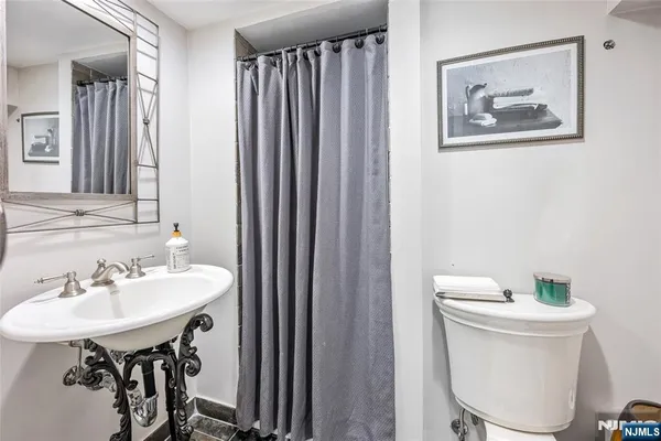 a bathroom with a sink a mirror and a toilet