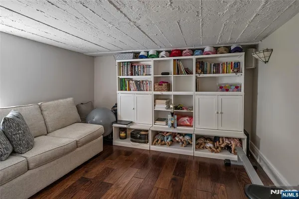 a living room with furniture a rug and a book shelf