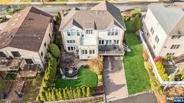 an aerial view of a house with garden space and street view