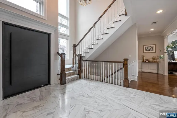 a view of a hallway with wooden floor and entryway