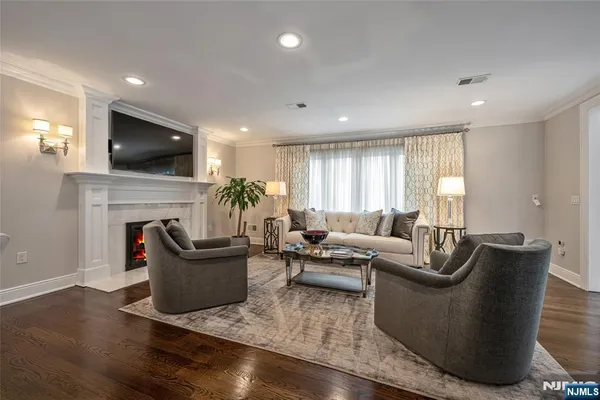 a living room with fireplace furniture and a flat screen tv