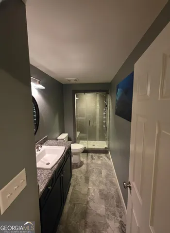 a bathroom with a double vanity sink and mirror with shower