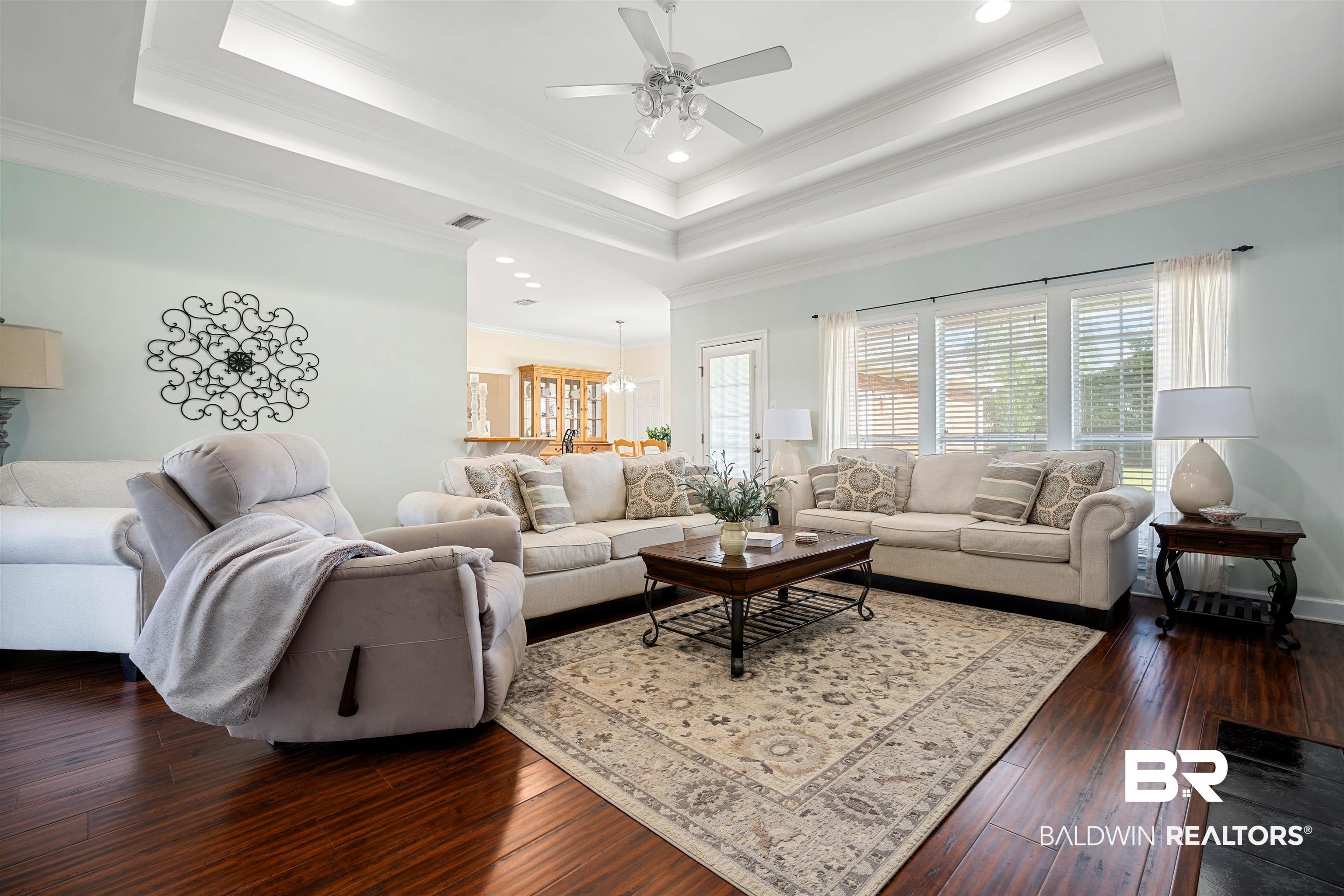 9552 White Castle Road Mobile, AL 36695 - Photo 6 of 31 Living area with crown molding, a tray ceiling, dark wood-style flooring