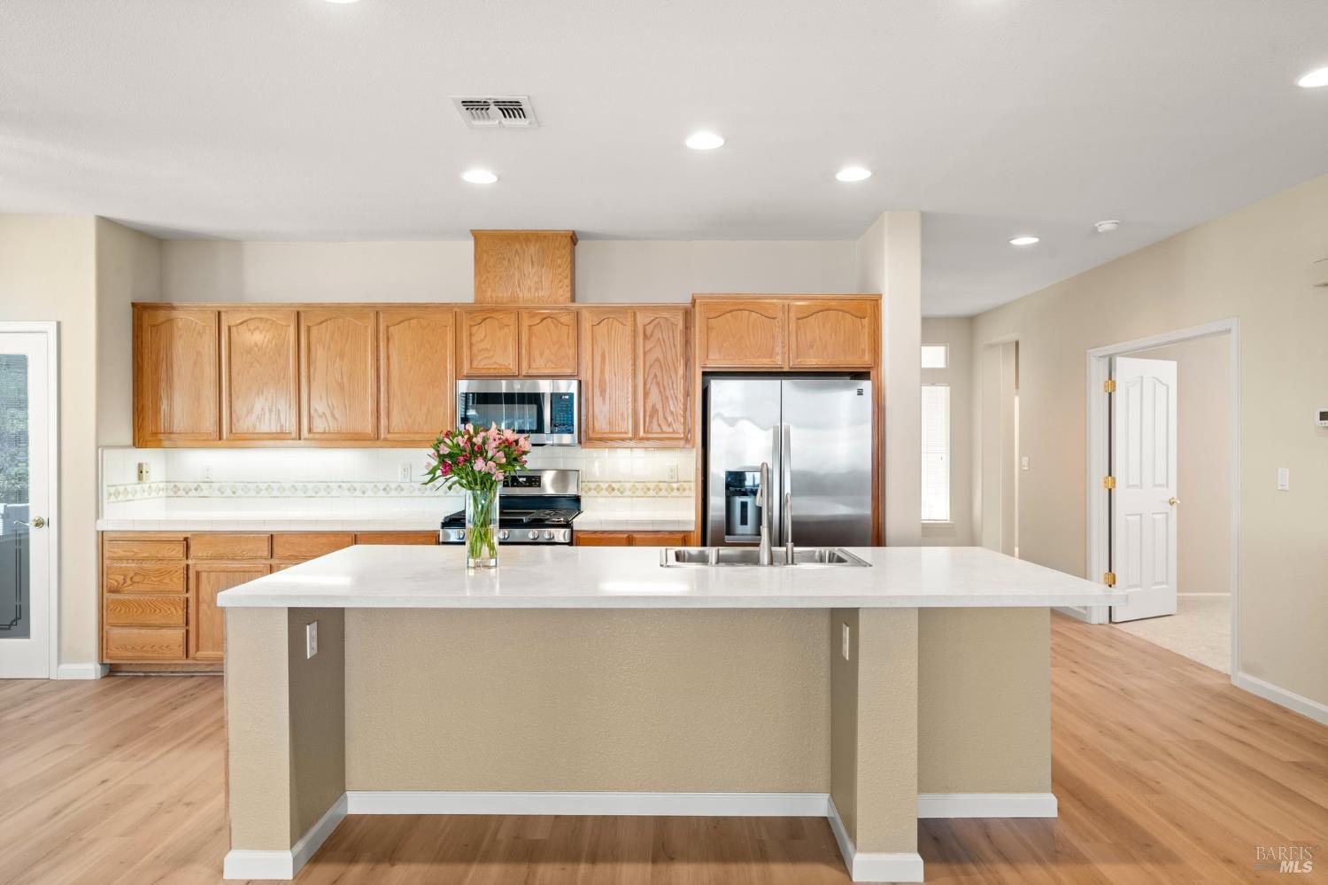 331 Crystal Downs Drive Rio Vista, CA 94571 - Photo 5 of 68 kitchen with new appliances, new LVP flooring, and new quartz counters and single bowl sink on the island