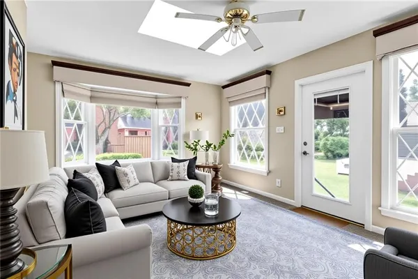 a living room with furniture and a potted plant