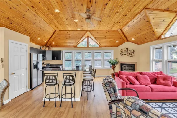 a living room with stainless steel appliances kitchen island granite countertop furniture and a kitchen view