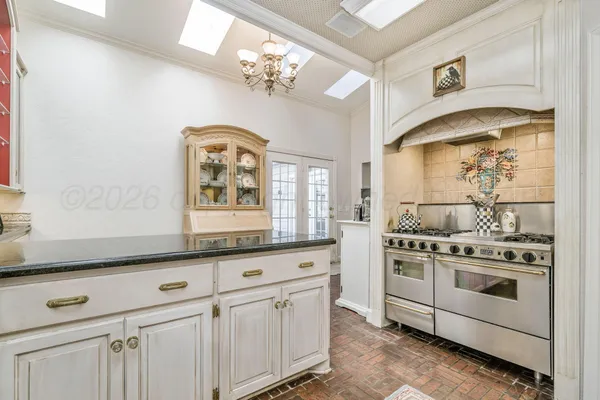 a spacious bathroom with a double vanity sink a large mirror a bathtub and