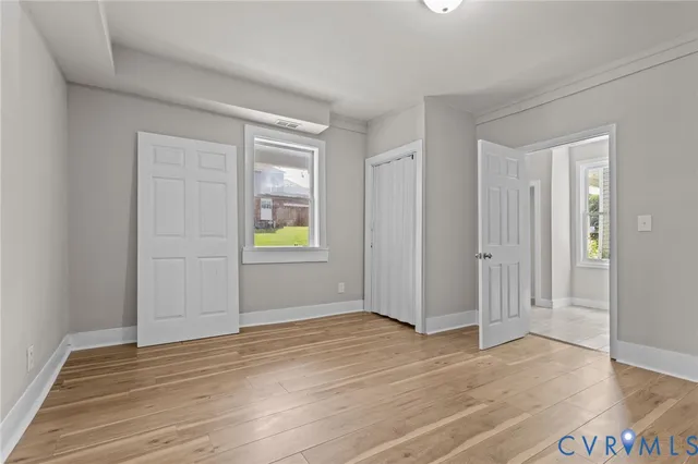 a view of an empty room with wooden floor