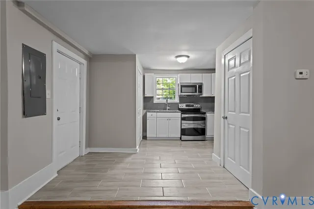 a kitchen with granite countertop a refrigerator and a stove