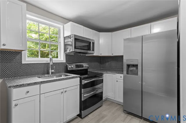 a kitchen with a refrigerator sink and microwave