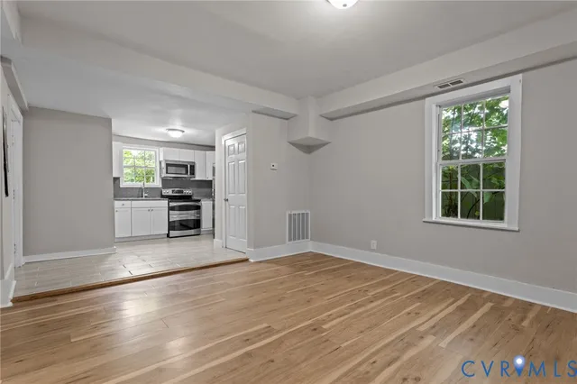 wooden floor in an empty room with a window