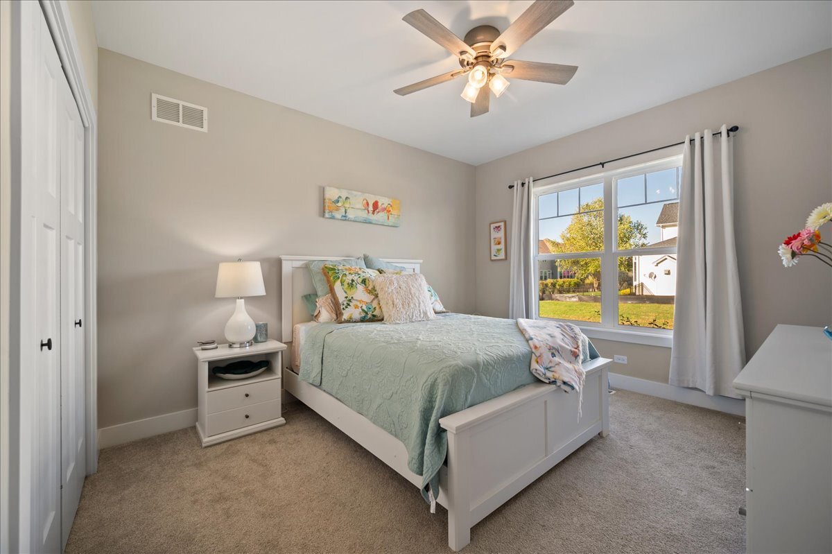 1383 Dodson Avenue Elburn, IL 60119 - Photo 17 of 25 a bedroom with a bed and a chandelier