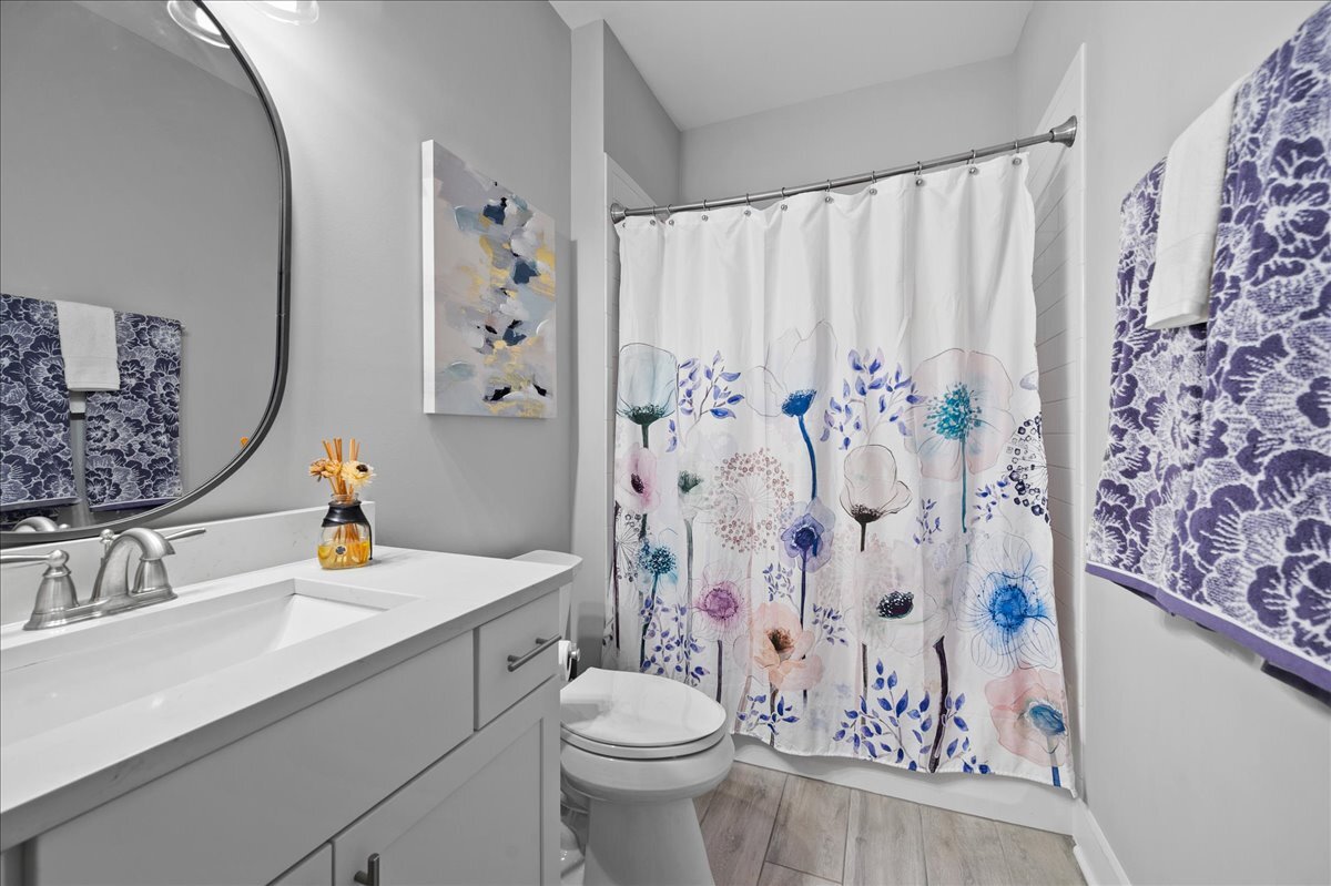 1383 Dodson Avenue Elburn, IL 60119 - Photo 18 of 25 a bathroom with a sink toilet and shower curtain