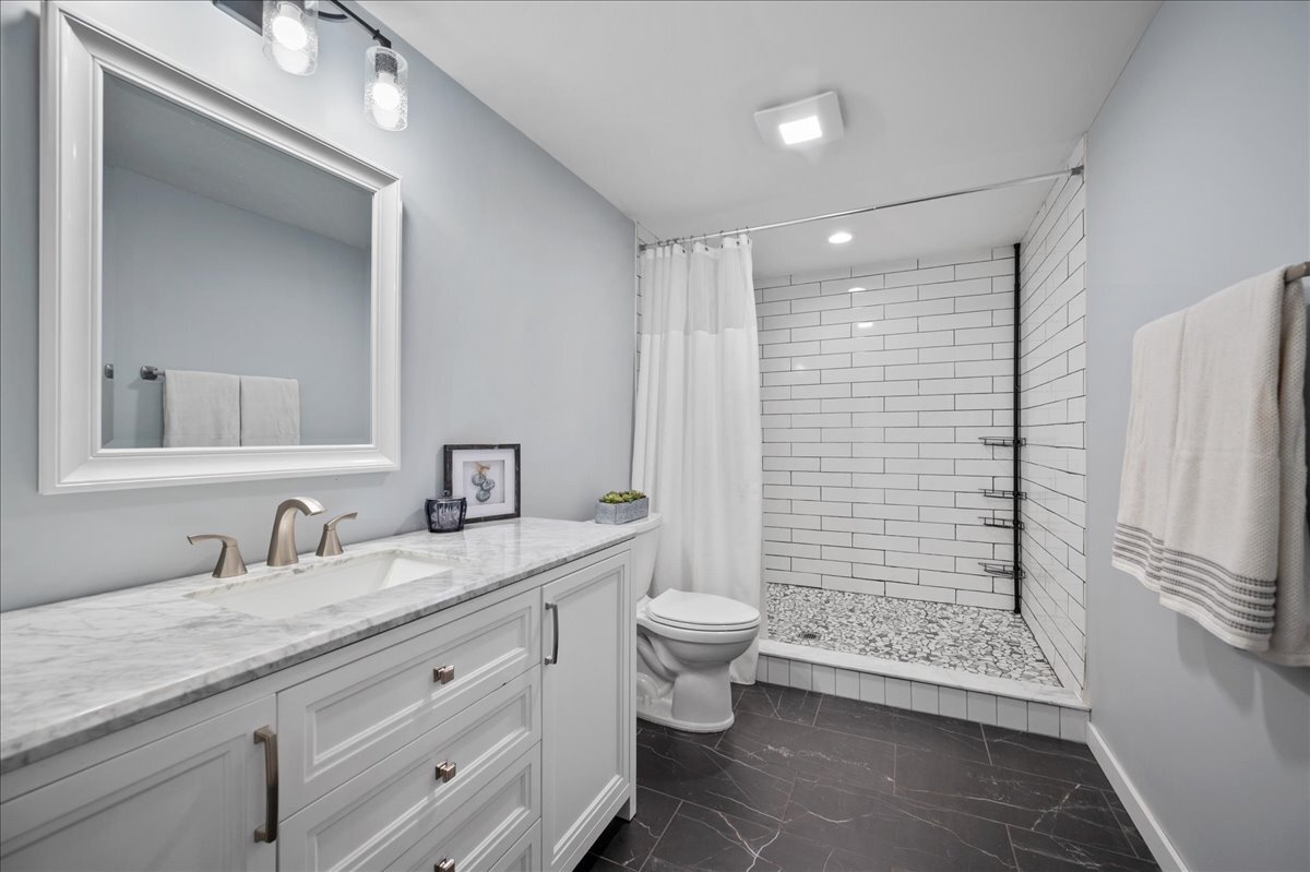 1383 Dodson Avenue Elburn, IL 60119 - Photo 20 of 25 a bathroom with a double vanity sink toilet and shower