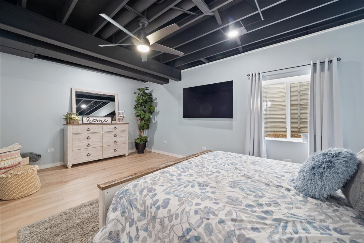 1383 Dodson Avenue Elburn, IL 60119 - Photo 22 of 25 a bedroom with a large bed a flat tv screen and a dresser