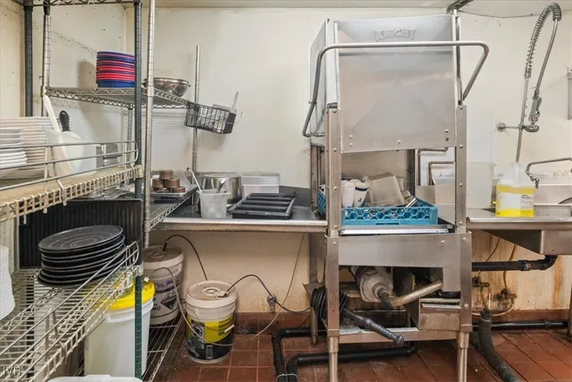 a view of a patio with table and chairs under an umbrella
