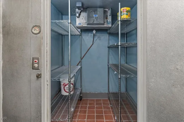 an aerial view of residential house with outdoor space and trees all around