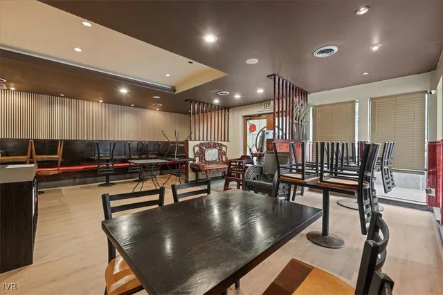 a living room with a wooden floor and furniture