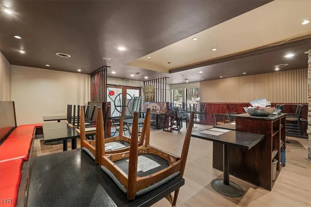 a living room with furniture pool table and a flat screen tv