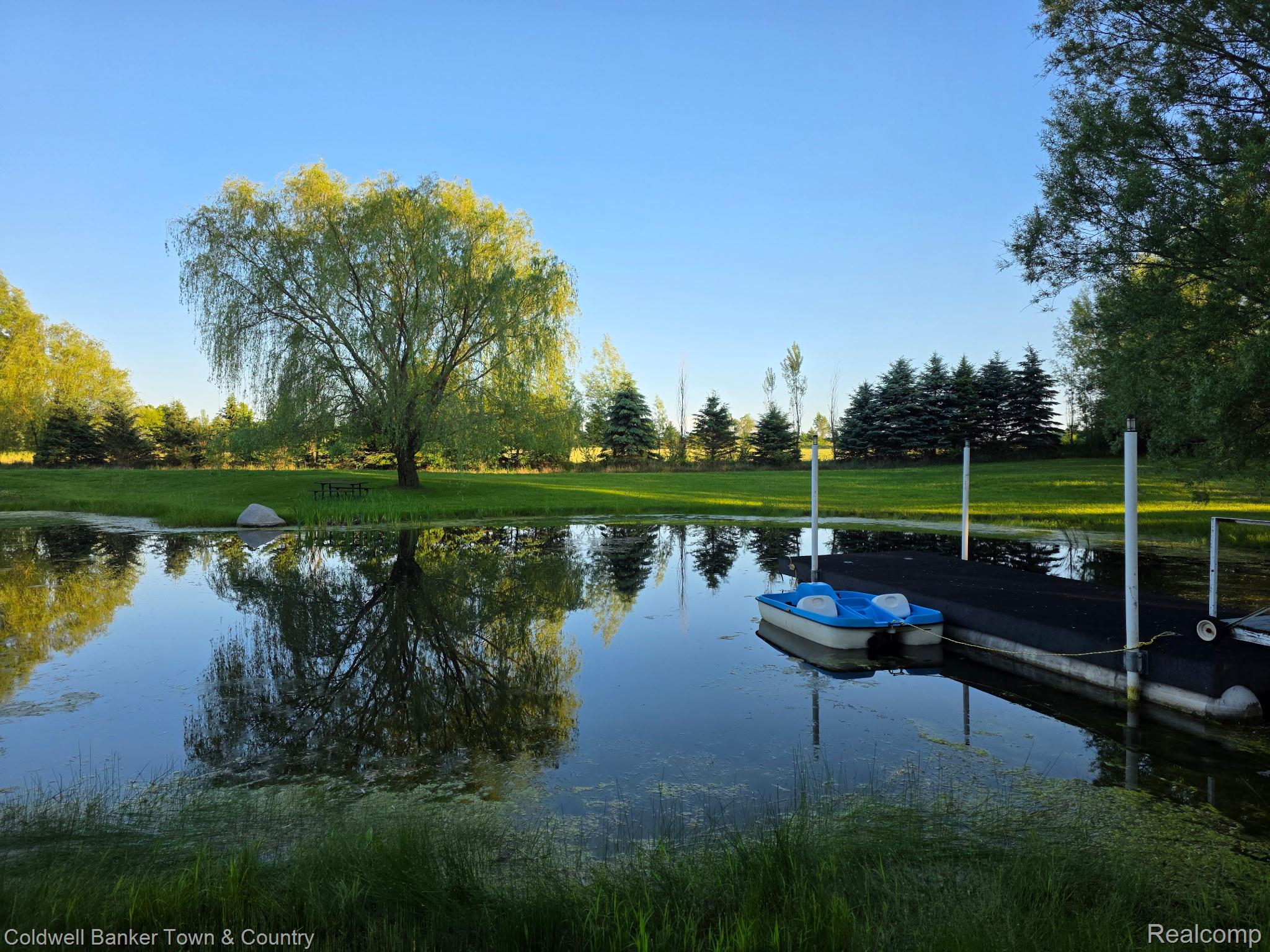 717 North Youngs Road Attica, MI 48412 - Photo 82 of 87 Expansive water feature with a floating dock and verdant perimeter landscaping