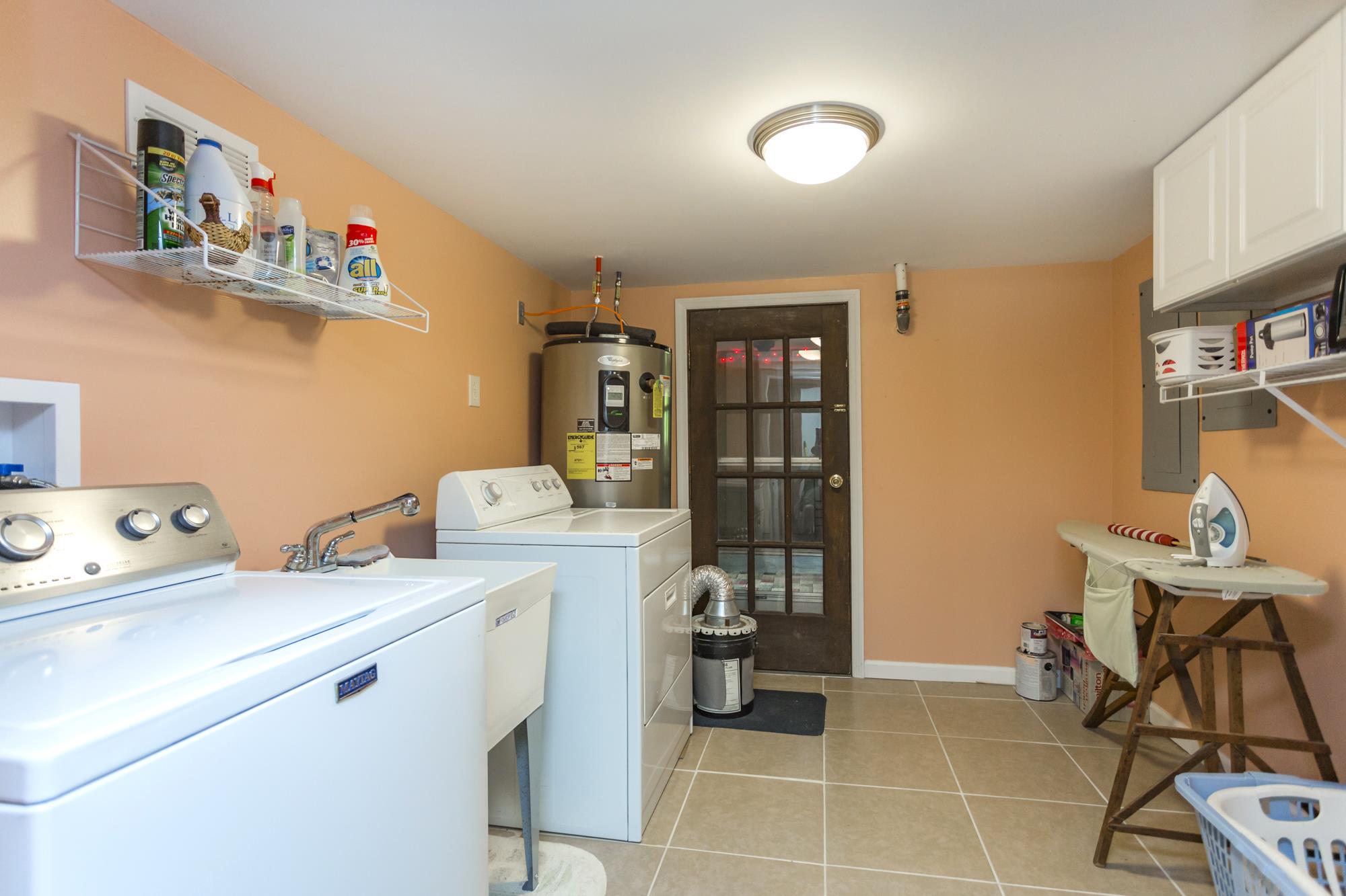 785 Danley Road Charlotte, TN 37036 - Photo 22 of 30 Laundry room downstairs opens to additional storage or possibly exercise room.
