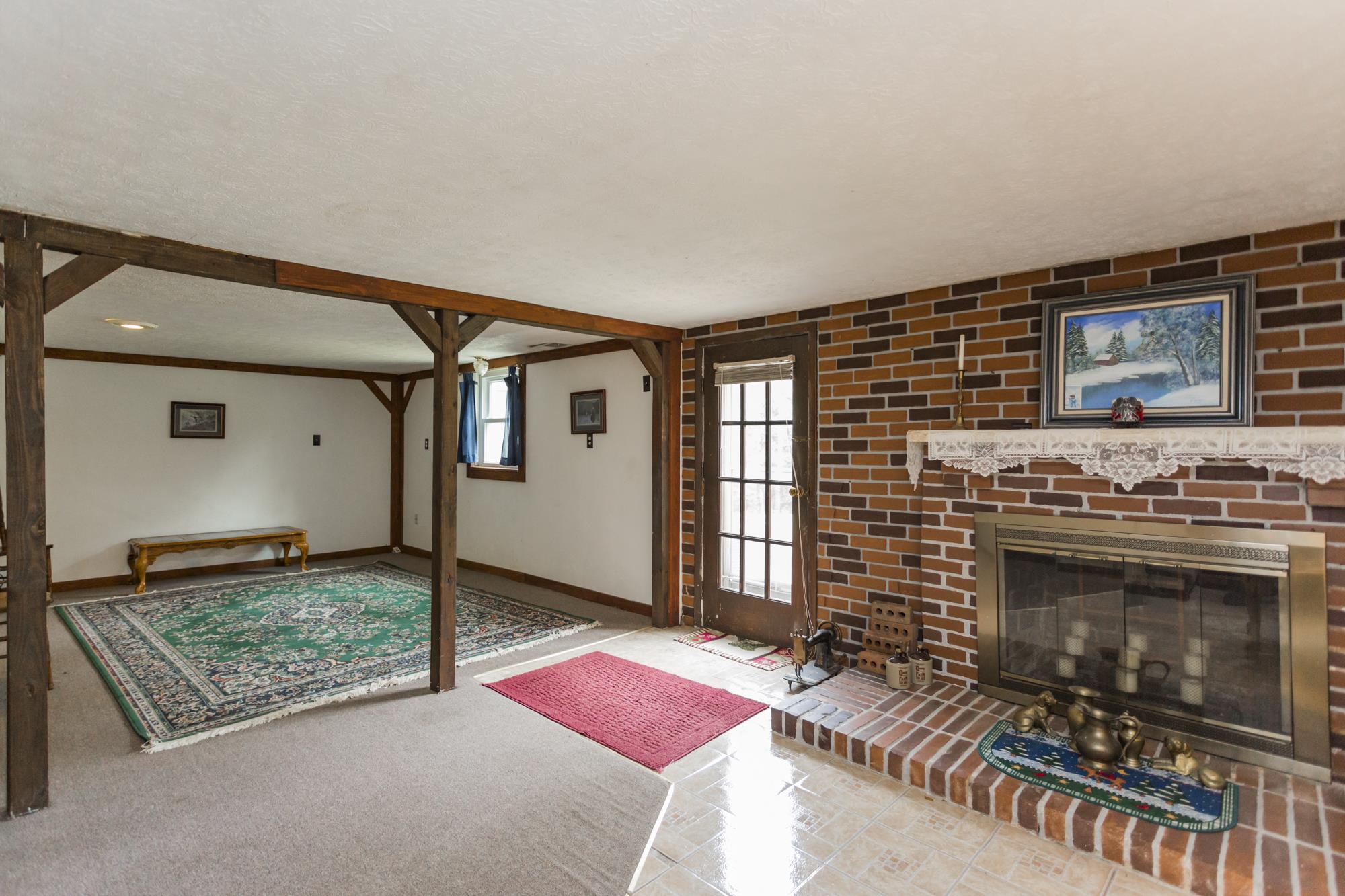 785 Danley Road Charlotte, TN 37036 - Photo 24 of 30 Original brick and exposed wooden beams give this room a great country feel