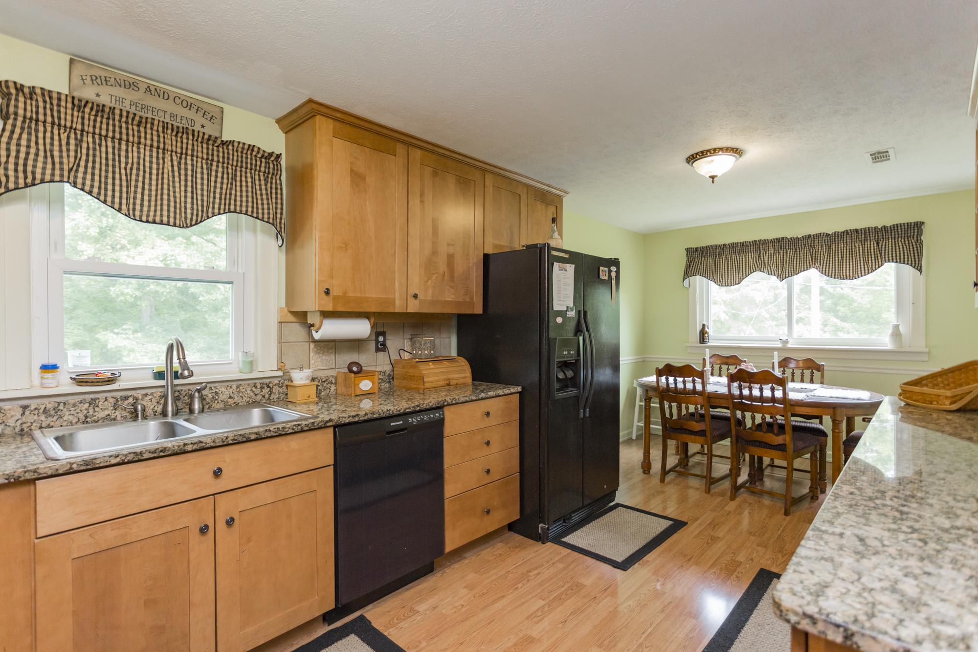 785 Danley Road Charlotte, TN 37036 - Photo 9 of 30 Eat in kitchen with granite counter tops and black appliance package.