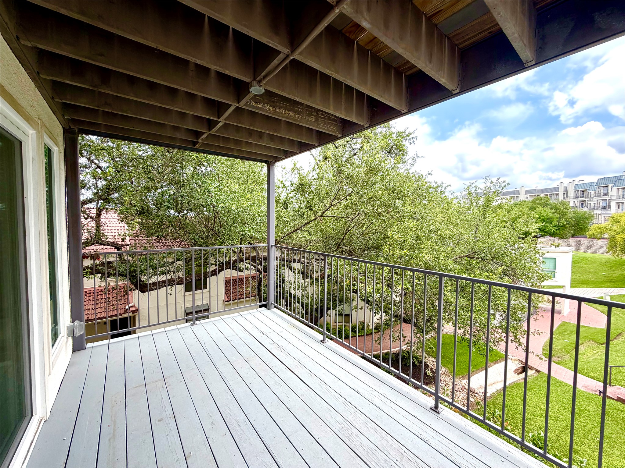 2918 Ranch Road 620 North, Unit C120 Austin, TX 78734 - Photo 11 of 34 Enjoy tranquil views from this elevated private balcony overlooking lush greenery.